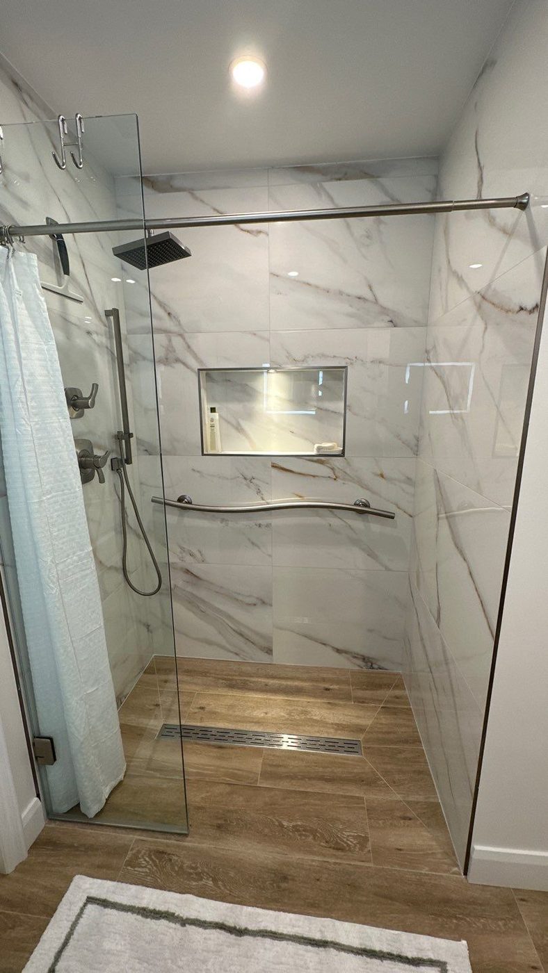Marble slab walk-in shower with rain head and linear drain