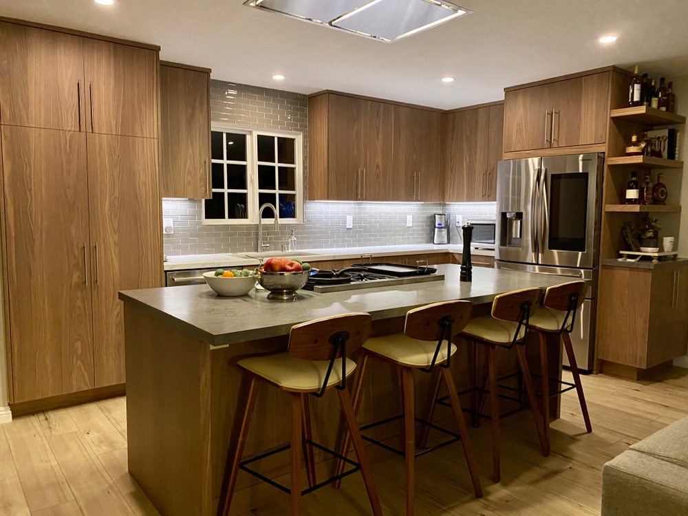 Modern walnut cabinetry kitchen with large island and bar seating