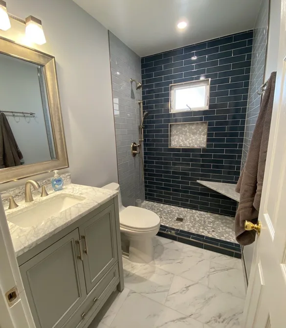 Master bathroom remodel in Long Beach, CA with navy subway tile shower and marble top vanity by Ten Eight Renovations