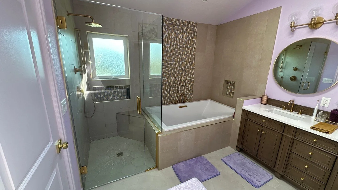 Remodeled bathroom with custom tile and fixtures by Ten Eight Renovations